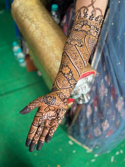 A full arm view of the personalized 'Saif' mehendi. The name is the centerpiece of the palm design.