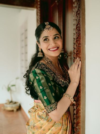 The joy of a bride is infectious. This candid shot captures her happiness, with the beautiful colors of her saree reflecting her bright spirit.