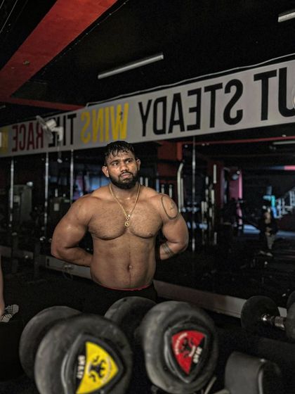 A powerful pose in front of the dumbbell rack. This is my playground.