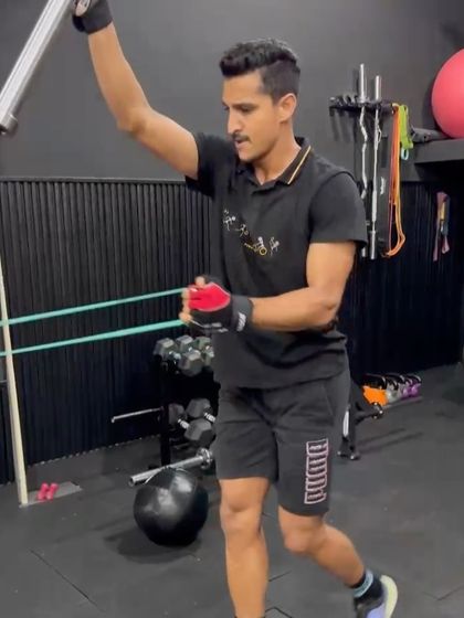 An athlete performing a landmine rotational press, a safe and effective exercise for building rotational strength and shoulder stability.