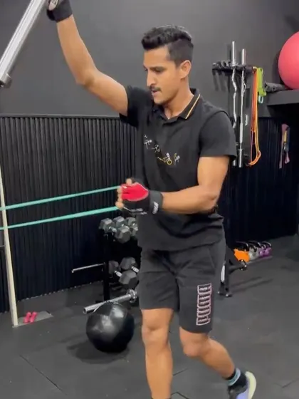 An athlete performing a landmine rotational press, a safe and effective exercise for building rotational strength and shoulder stability.