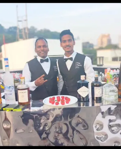 Our bartenders at a rooftop event, with the city skyline in the background. We can set up a premium bar anywhere, bringing our expert service to you.