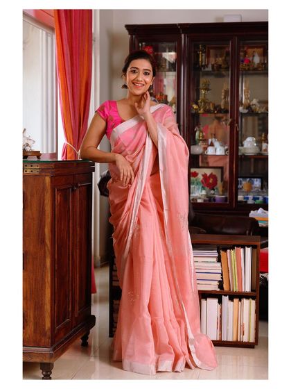 A full-length shot showing the model leaning against a desk, perfect for a "work from home" or casual elegance theme.