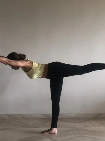 The warrior III pose, a test of balance and concentration. This yoga asana helps build stability through the standing leg and core, which is crucial for dancers.
