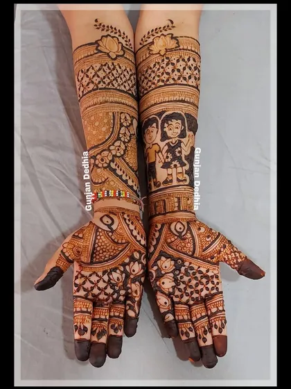 A sweet sibling portrait incorporated into a full-hand mehendi design, surrounded by traditional peacock and floral patterns.