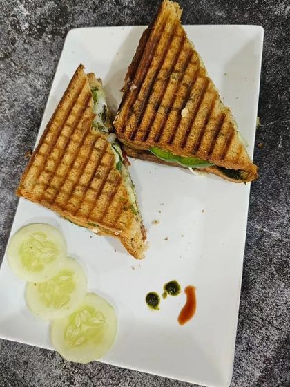 A classic grilled sandwich served with a side of cucumber, simple and delicious.