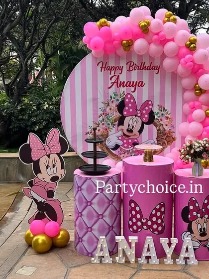 We can transform any space, including outdoor areas like this poolside, for a child's birthday. This Minnie Mouse themed party features custom character stands, themed plinths for the cake, and a vibrant pink balloon arch.