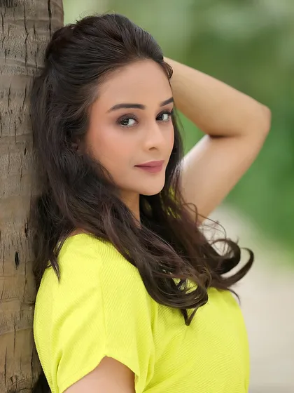 A fresh and natural outdoor portrait of actress Harleen Kaur. This kind of shot is perfect for demonstrating a grounded, girl-next-door appeal.