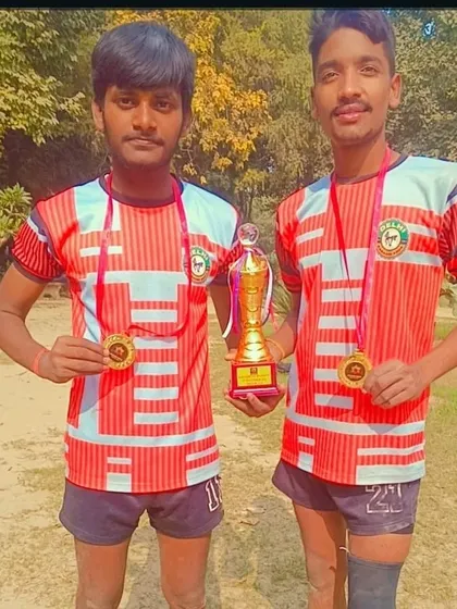 Two of our champions showing their first-place medals and the tournament trophy. Their synchronized effort on the mat led to this fantastic result.