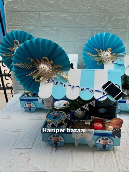 Another view of the Boss Baby cart hampers, showing the elegant paper fan and themed details.