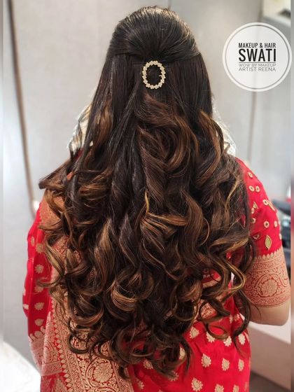 A beautiful reception hairstyle by my artist Swati. The hair is styled in voluminous curls with a simple, elegant accessory at the crown.