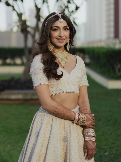 Sheena looking absolutely radiant in the soft, natural light. Her bridal makeup was designed to enhance her features with a soft golden glow, defined eyes, and a muted lip for a sophisticated finish.