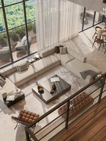 This aerial view showcases our approach to creating open, light-filled luxury living spaces. The double-height windows flood the room with natural light and offer expansive views of the surrounding greenery, while the layout provides a clear connection between the living, dining, and outdoor terrace areas.