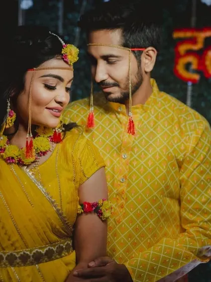 A sweet portrait of the couple during their Haldi ceremony, dressed in matching yellow outfits.
