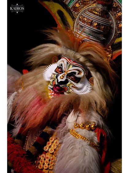 A close-up on the intricate mask and costume of the Kathakali performer, highlighting the incredible craftsmanship of the art form.