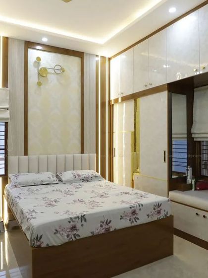 This bedroom features a modern TV unit and a cozy window seat, creating a multi-functional and relaxing space.