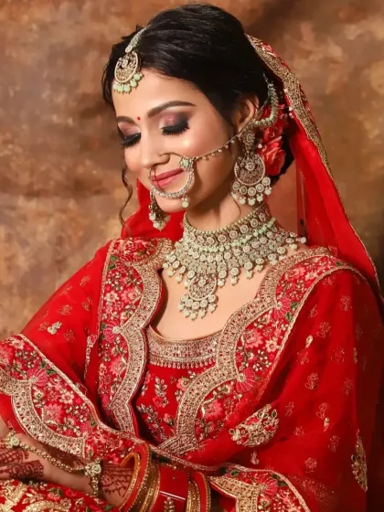 A candid moment of a happy bride. This look features coppery-gold eyeshadow and a soft red lip, a beautiful combination for traditional wear.