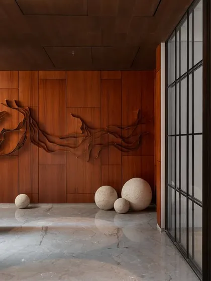 Upon entering, a custom-designed, three-dimensional wooden art piece serves as a powerful focal point, demonstrating a commitment to integrating art directly into the architecture.