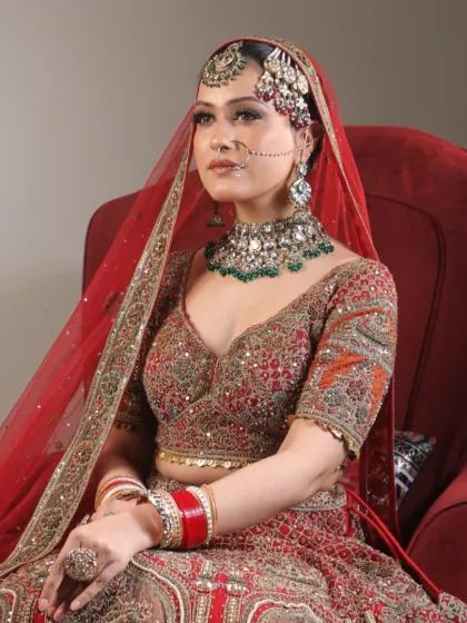 Every bride deserves to feel beautiful on her big day. This bride is glowing in her red lehenga, with makeup that enhances her natural beauty and joy.