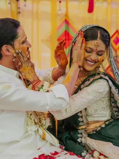 The Haldi ceremony is all about fun and uninhibited joy. This photo of the couple playfully applying turmeric paste is a great example of the unposed, happy moments I strive to capture during wedding celebrations.