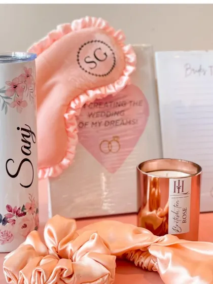 A complete bridal essentials kit including a personalized tumbler, a "Bride's To-Do List," a scented candle, and a monogrammed eye mask.