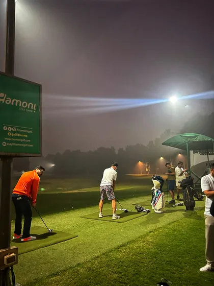 The fog creates an atmospheric backdrop for our night golfers, who are still out there grinding.