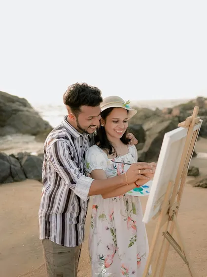 A close-up of the couple collaborating on their artwork. It's a beautiful metaphor for building a life together.