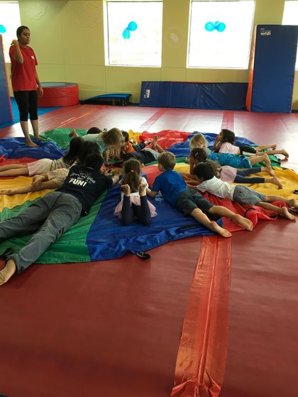 A wide view of our parachute cool-down, showing how we manage the group to ensure everyone is included and winding down together.