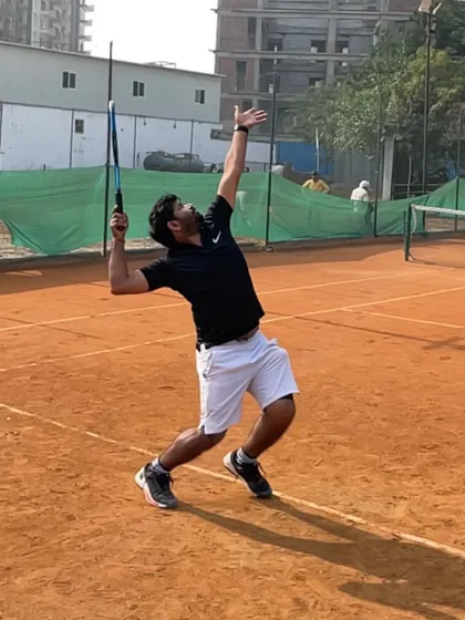 A snapshot of my serve at the peak of my extension, demonstrating the trophy pose.