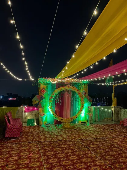 The main backdrop for the Mehndi ceremony, beautifully lit with green lights.
