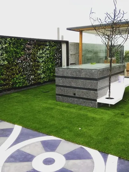 I design complete terrace makeovers. This project combines a custom artificial vertical garden with durable artificial grass and a modern seating area, creating a functional and beautiful rooftop escape.
