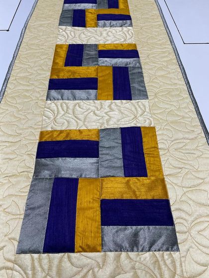 A close-up of the silk table runner, showing the sheen of the fabric.