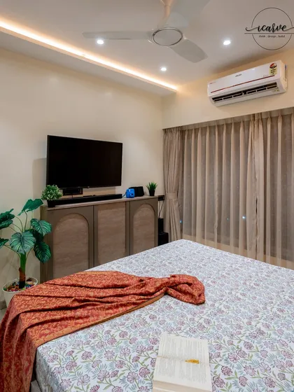 A clean and modern bedroom design with a custom TV console and warm lighting.