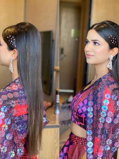 A sleek, open look with a half-up style and sparkling clips. This is a chic and modern way to wear your hair down for a party.