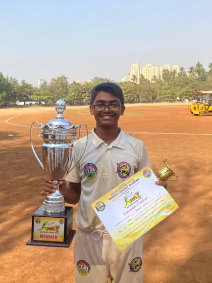 One of our star players from the U-17 MPL winning team, posing with the championship trophy and his winner's certificate.