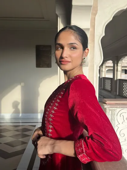 A stunning shot of model Kashish Kapoor for the House of Pataudi campaign. The makeup is clean and elegant, with a focus on flawless skin to complement the rich velvet texture of the outfit.