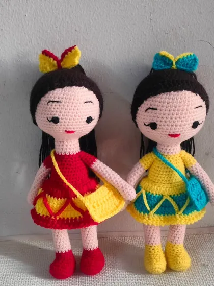 Two friends together. One has cute cherry hair clips and the other is a beach doll.