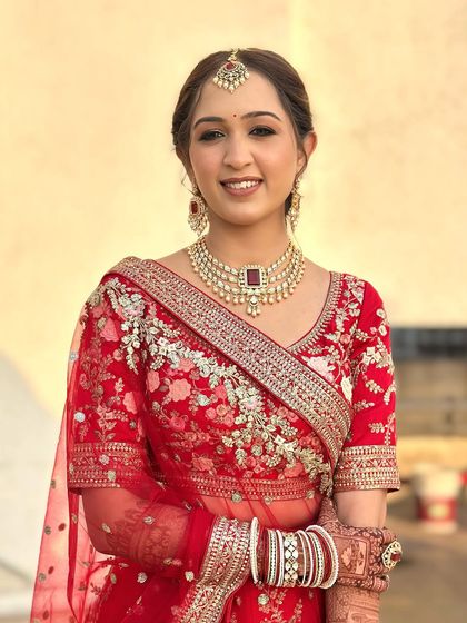 A beautiful portrait of Twinkle in her red bridal lehenga. The makeup is radiant and glowing, exactly as she wanted, making her look and feel like a princess.