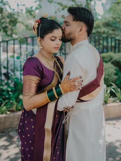 A tender kiss on the forehead. This classic gesture of affection is captured beautifully, highlighting the groom's love and the bride's serene happiness.