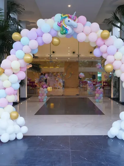 A grand entrance for a Unicorn-themed birthday party, featuring a massive balloon arch in pastel colours that welcomes guests into a magical world.