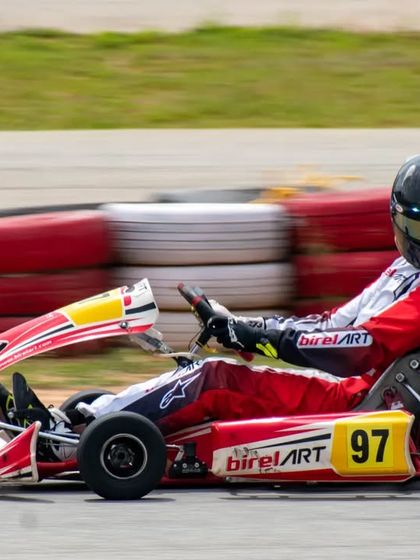 Driver Muktak Joshi in his number 97 kart, navigating a corner with skill. This shot captures the connection between driver and machine that we cultivate.
