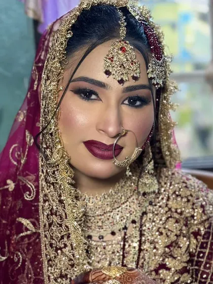 A portrait of the royal bride, looking directly at the camera. Her confidence shines through, enhanced by the bold and powerful makeup.
