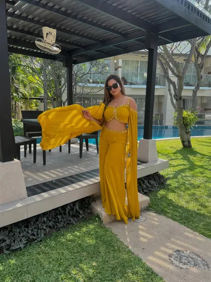Hello Thailand! Dressed in a vibrant yellow outfit, ready to bring the sunshine and energy to a poolside Haldi ceremony at this beautiful destination wedding.