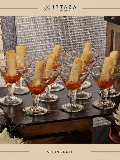 Spring Rolls served in martini glasses with a dipping sauce at the bottom. An elegant and practical way to serve this classic appetizer.