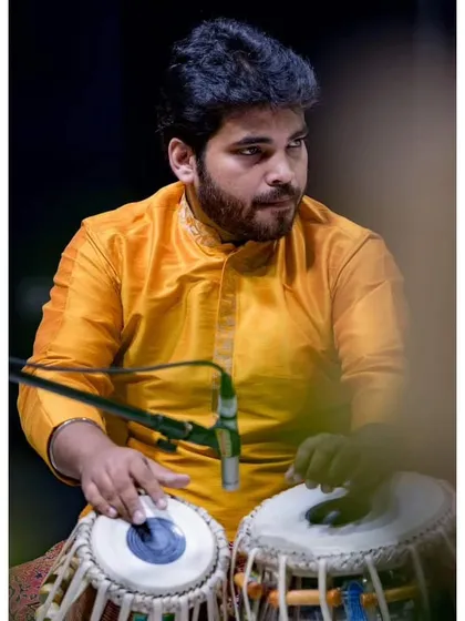 On stage, lost in the rhythm of the tabla during the Malhar Festival. This is the culmination of countless hours of sadhana, where the music flows and connects with the audience.