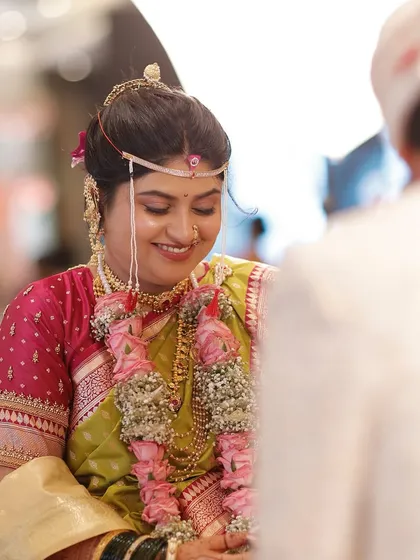 The bride's smile during the rituals. The minimal makeup approach ensures she looks like herself, just more radiant, even in the most intimate moments.