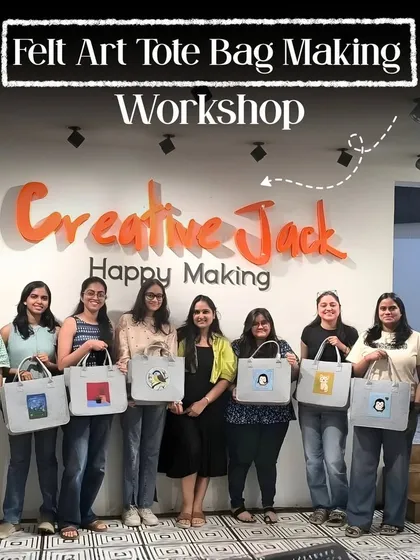A group of smiling women proudly displays the felt art tote bags they created in a workshop at my Thane studio. It's a fun and practical craft that everyone enjoys.