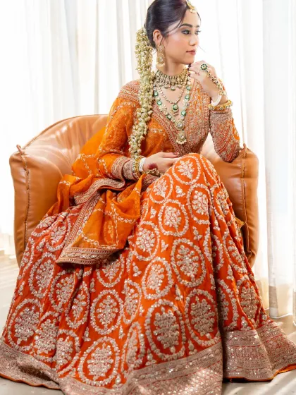 A full view of our royal orange lehenga. The way it sits and flows shows the quality of the fabric and the expert craftsmanship.