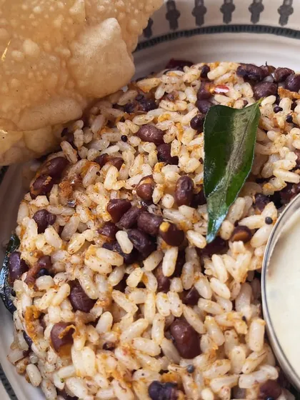 This is our Red Cowpeas Bowl. We sauté Kerala Matta rice with nutty Red Cowpeas Thoran in a chatti, and pack it for you with Moru Curry and a crispy Papadum. It's a nutritious and delicious detoxifier.