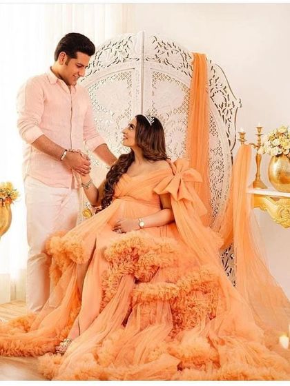 Another beautiful shot of the peach ruffled gown, this time with a statement bow. This dress is versatile and can be styled in different ways to suit your vision.